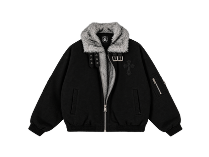 A black bomber jacket with a gray faux-fur collar, featuring a front zipper, silver-tone hardware, a cross patch on the chest, and a zippered sleeve pocket, shown against a plain white background.